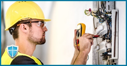 An electrician inspecting an electrical panel.